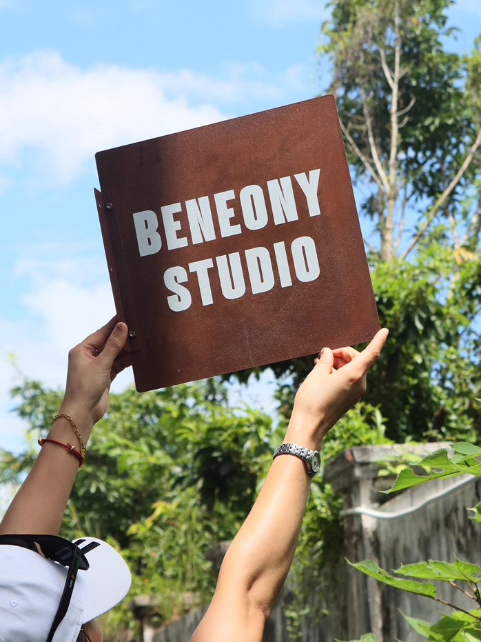 Real Life Scale Reference of Custom Rusted Iron Sign against Blue Sky.