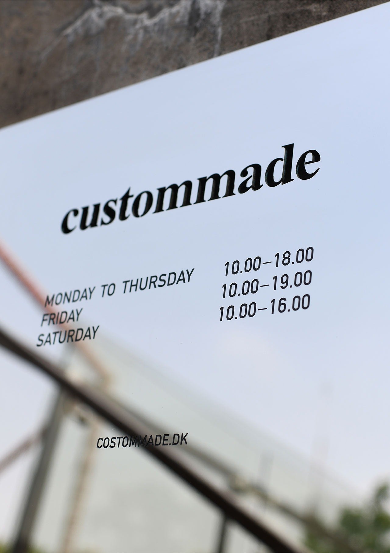 Modern business plaque made of mirror stainless steel with deep acid-etched black text ("D&D Watch"), displaying sharp details and premium gloss