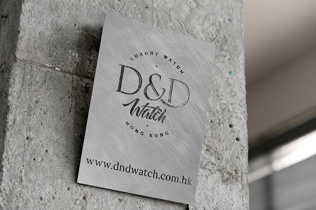 Custom stainless steel business plaque mounted on a rough concrete wall, creating a perfect modern industrial aesthetic for luxury brands