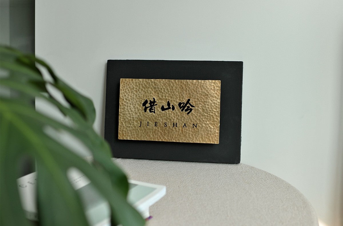 Modern office decor signage with brass and steel materials.