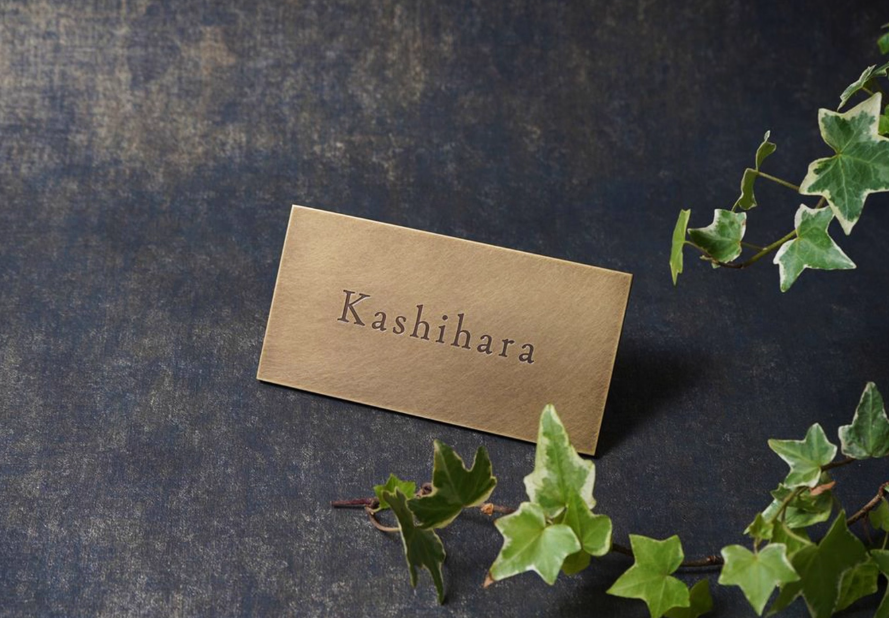 Angled view of a vintage-style brass nameplate. Shows the metallic sheen of the hammered finish and precision engraved lettering for professional office signage.